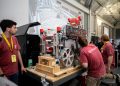students inspect lunar mining robot