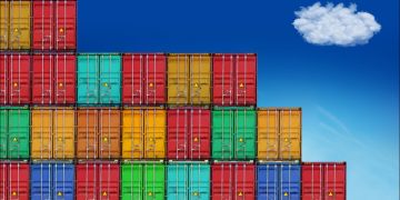 Photo of coloured shipping containers against a blue sky