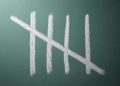 Five tally marks on blackboard