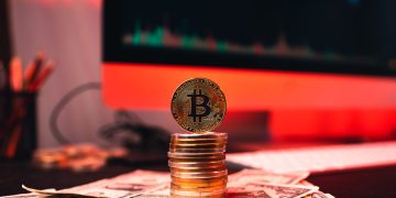 Investors yank a record US$453 mln from Bitcoin: report, Bitcoin on a home computer chart and money and investment