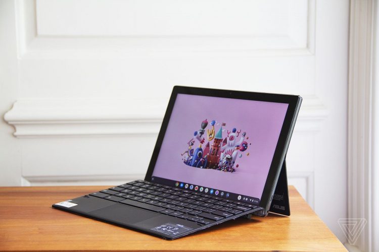 The Asus Chromebook Detachable CM3 open, angled to the left. The screen displays a cartoon city scene on a pink background.