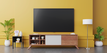 A TV mounted to the wall of a living room.