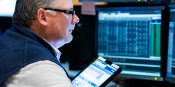 Dow slips 100 points as investors monitor recession signals, falling oil prices