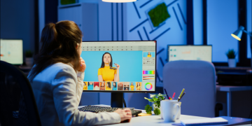 A woman viewing and editing photos on a Windows desktop PC.