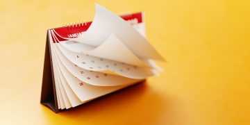 Calendar pages flipping through months. [time / past / future / history / what