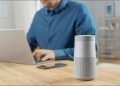 Person using bluetooth speaker with laptop
