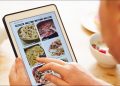 Person looking at food on tablet.