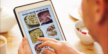 Person looking at food on tablet.