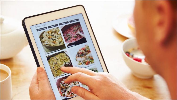 Person looking at food on tablet.