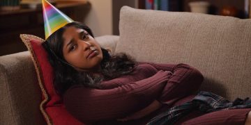 Never Have I Ever Season 3 Devi frowning on couch with birthday hat