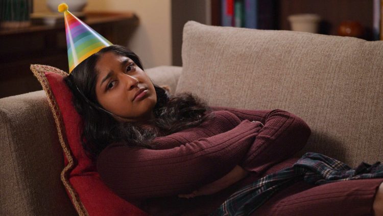 Never Have I Ever Season 3 Devi frowning on couch with birthday hat