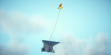 Yellow bird carries an anvil. growth marketing during a recession