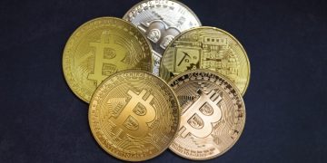 Bitcoin coins on black background, top view