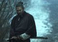 Jason Momoa as Baba Voss about to unsheath a sword in See