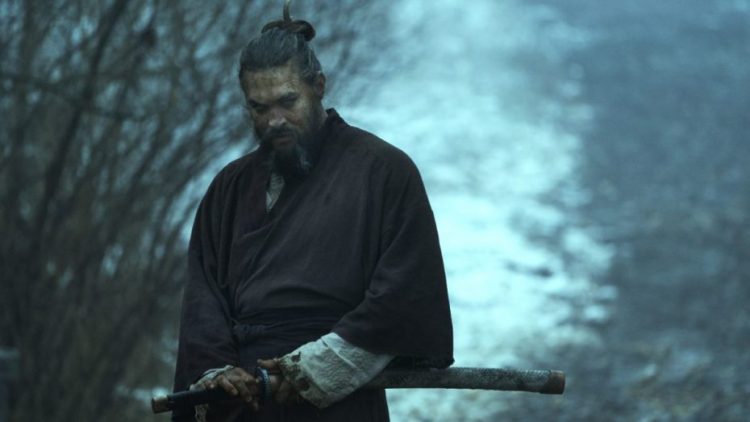 Jason Momoa as Baba Voss about to unsheath a sword in See