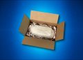 A fragile or bulky electronics item being packaged for shipping in a box on a blue background.