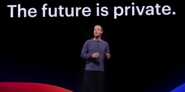 Mark Zuckerberg standing in front of a slideshow that says "The Future Is Private"at the F8 2019 event.