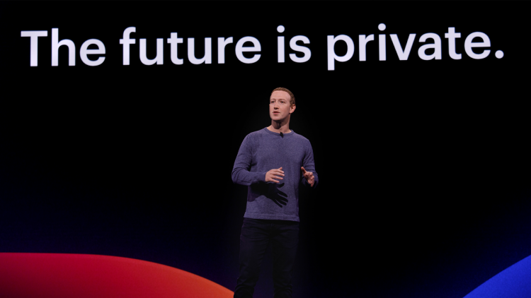 Mark Zuckerberg standing in front of a slideshow that says "The Future Is Private"at the F8 2019 event.