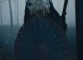 Dane DiLiegro as The Predator with a shield in the forest in Prey