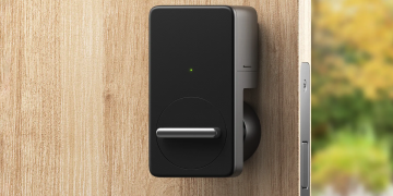 The SwitchBot Wi-Fi smart lock on a door.