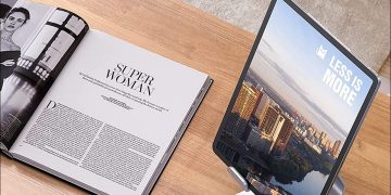 iPad on stand next to book