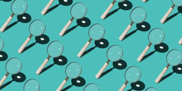 Magnifying Glass Focusing Sunlight Into a Point Repetition on Turquoise Colored Background High Angle View; technical due diligence