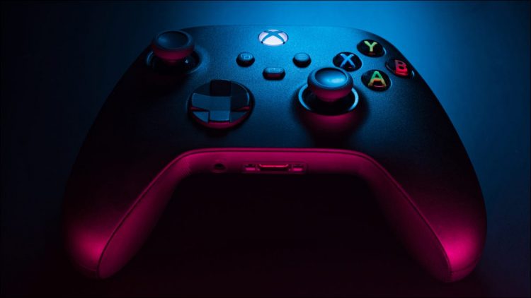 Closeup of a carbon black Xbox Series S controller in blue and red lighting.