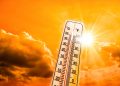 thermostat against a sun backdrop