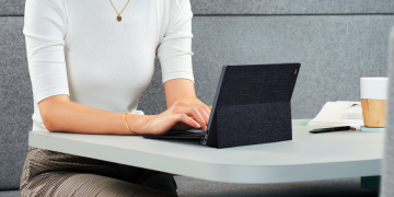 Someone typing on the ASUS ExpertBook B3 Detachable at a table. It's very compact!