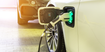 EV plugged in by a regular car