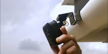 A camera mount attached to a home's gutter system.