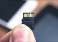 MicroSD card in hand.