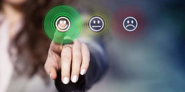 happy employee selects the happiness emoji button to indicate job satisfaction