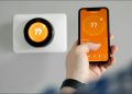 person using nest app to set nest thermostat temp