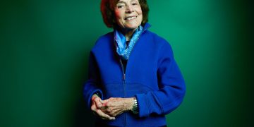 Portrait of Sylvia Earle against a green background