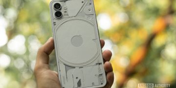 Nothing phone white in hand showing back