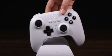 Plugging the 8BitDo Ultimate controller into its charging dock.