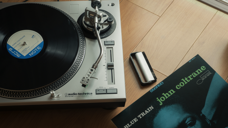 A John Coltrane LP next to an Audio-Technica turntable.