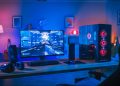 A gaming PC in a room lit by colorful lights.