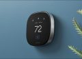 An ecobee smart thermostat on a blue wall.