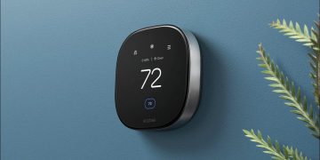 An ecobee smart thermostat on a blue wall.