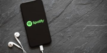 Spotify running on iPhone with earbuds