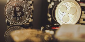 BTC Bitcoin and XRP Ripple Coins Between Casino Chips. Entertainment and Modern Blockchain Payments Concept.