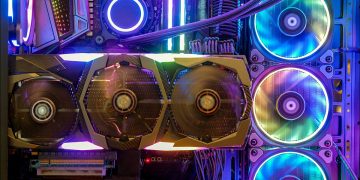 A GPU in a case colorfully lit by RGB lighting.