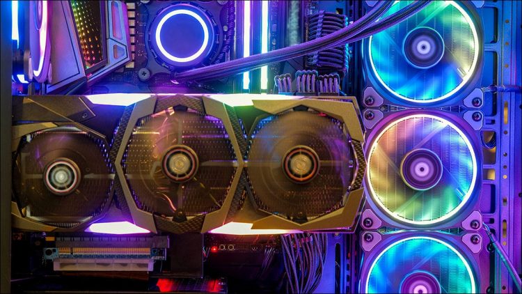 A GPU in a case colorfully lit by RGB lighting.