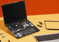 A framework laptop taken apart on a table.