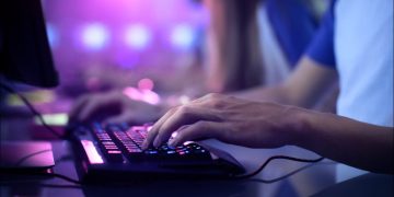 Gamer's hands on a PC keyboard
