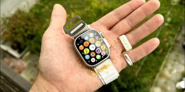 A man holding an Apple Watch in his palm