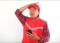 Man with a frustrated expression while using a smartphone.