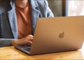 Woman using a MacBook on a desk